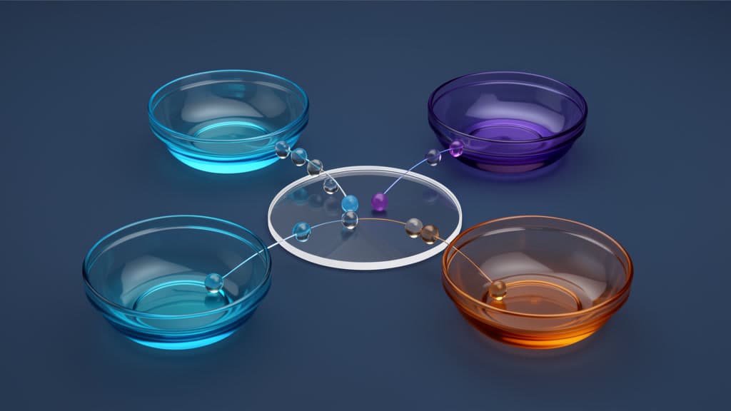 Four blue, violet, and amber glass bowls surround a clear ring while colored glass beads meet along thin light paths.